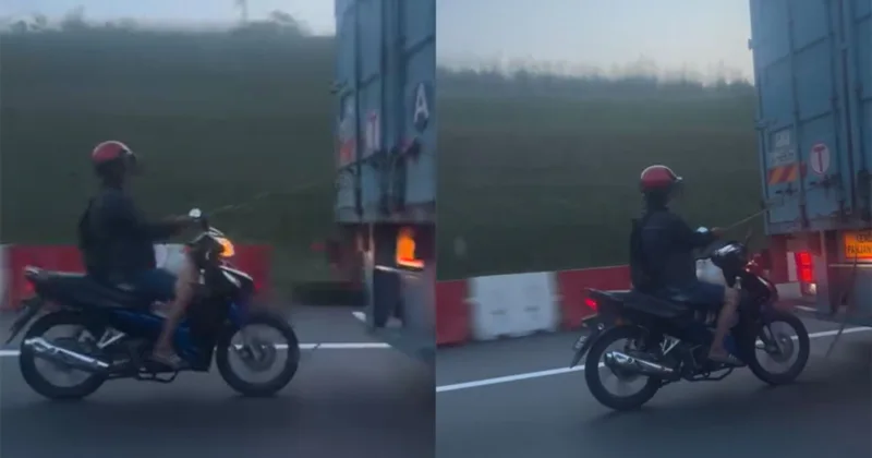 高速道路でトラック後ろを牽引されるモーターサイクリスト映像が撮影